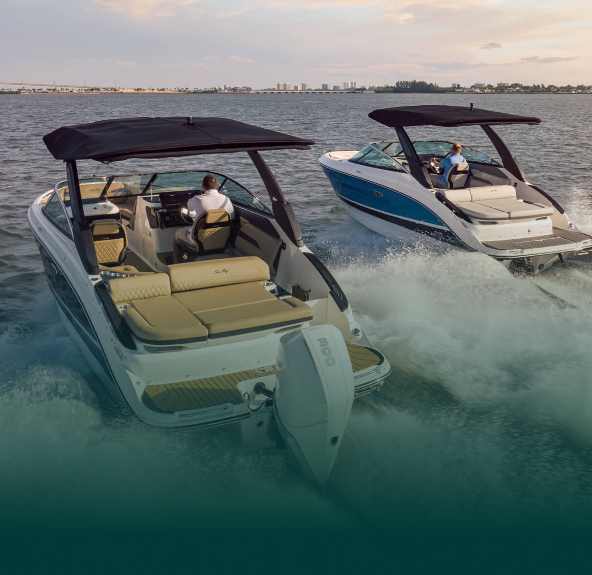 Two boats near each other driving across the water.