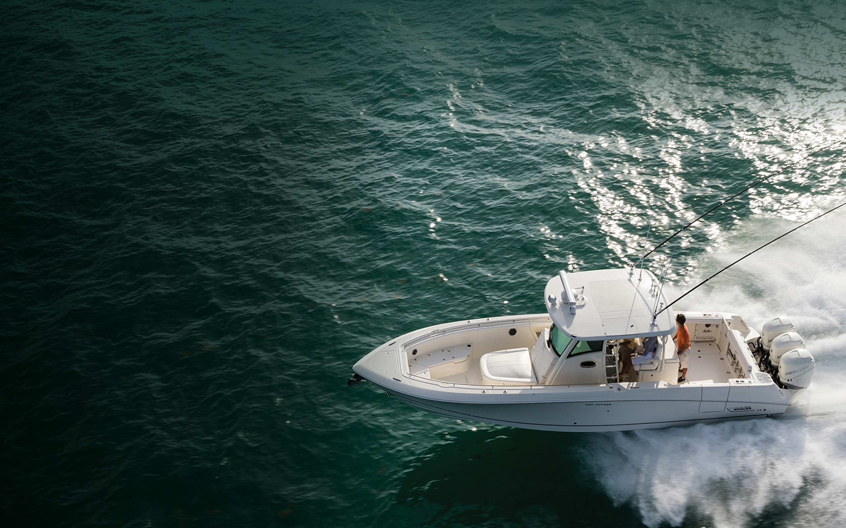 People sailing blue-green waters on a charter boat.