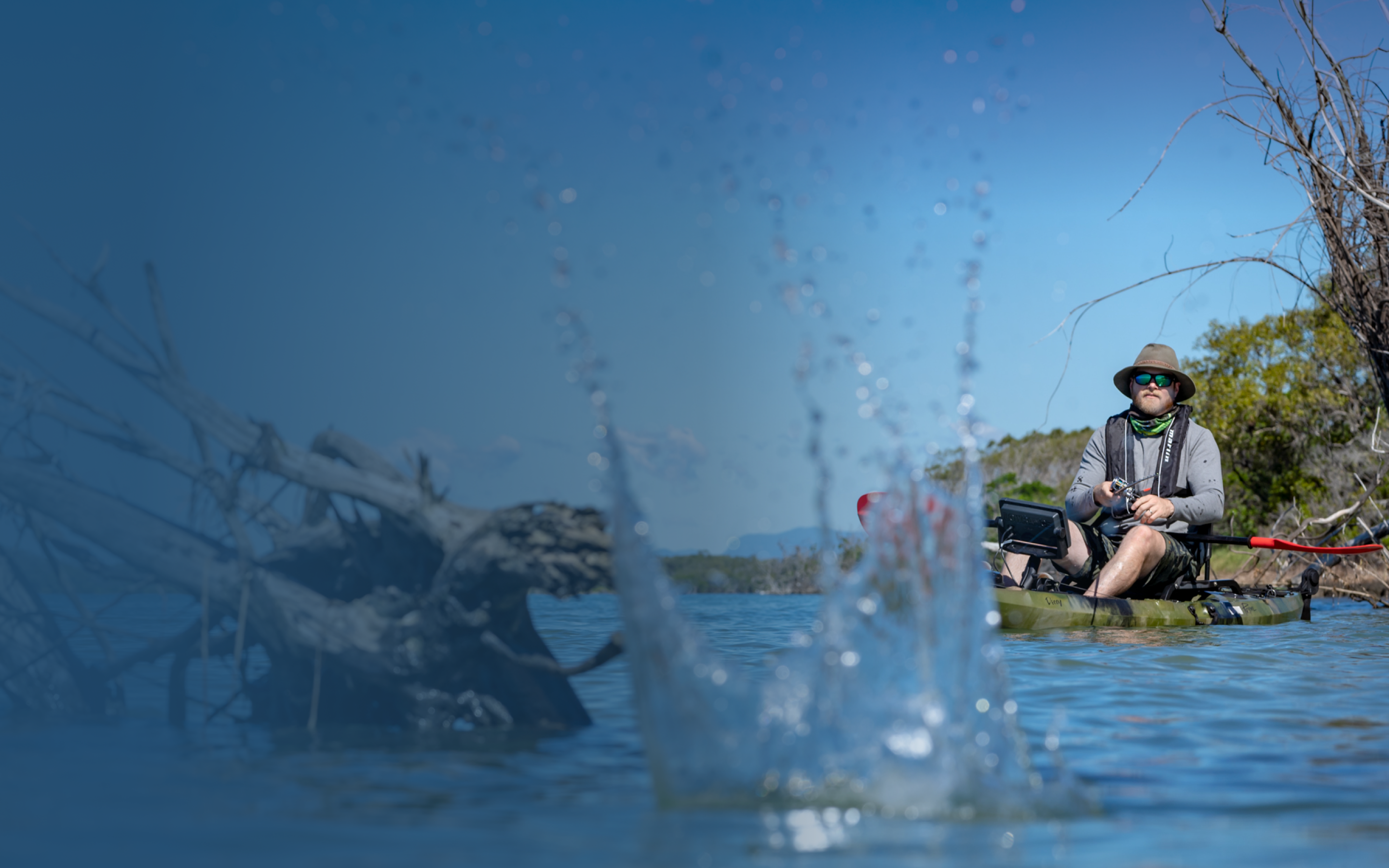 A man fishing on a kayak. 