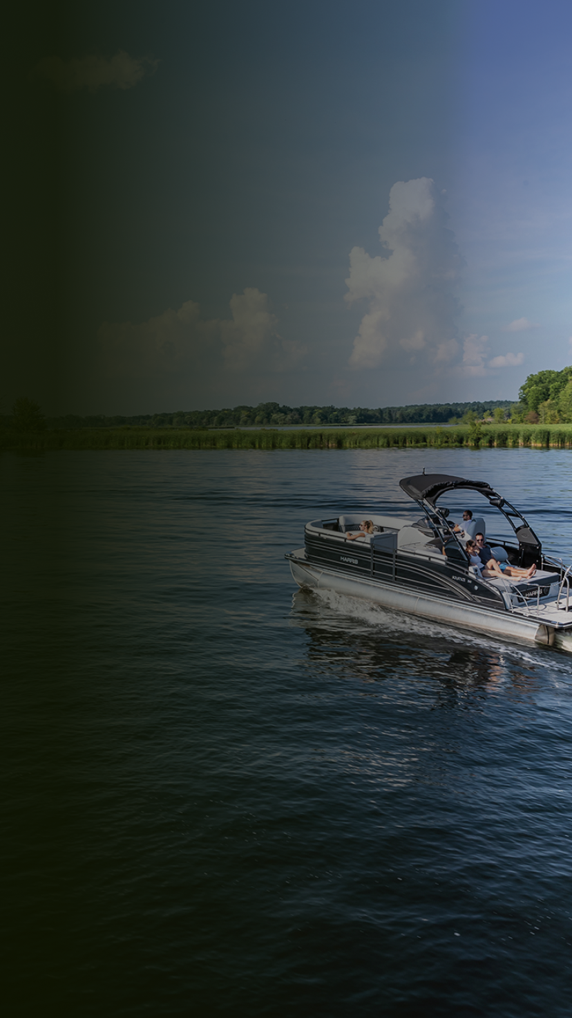 Friends cruising a lake on a luxury pontoon boat.