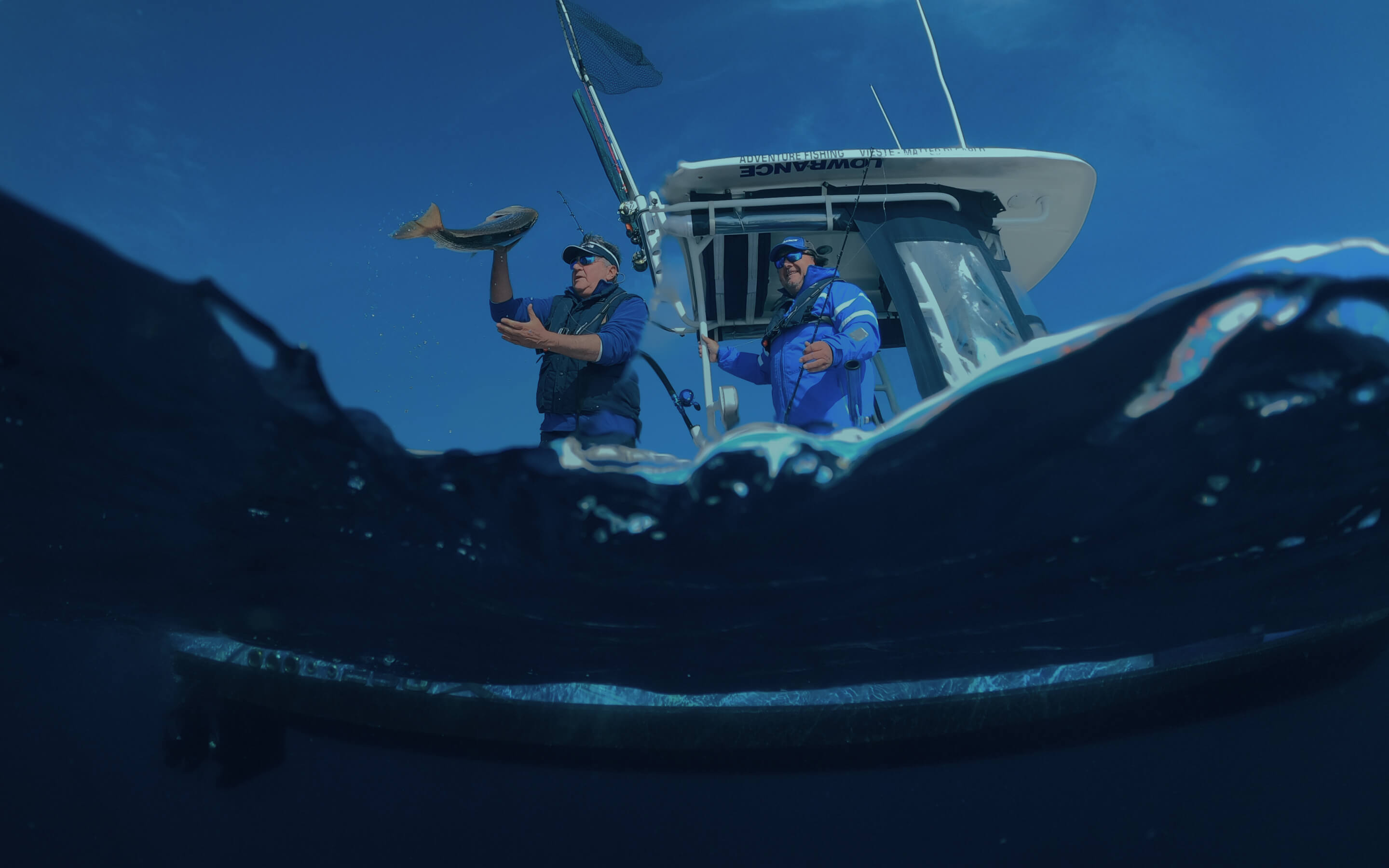 Two men fishing on a boat.