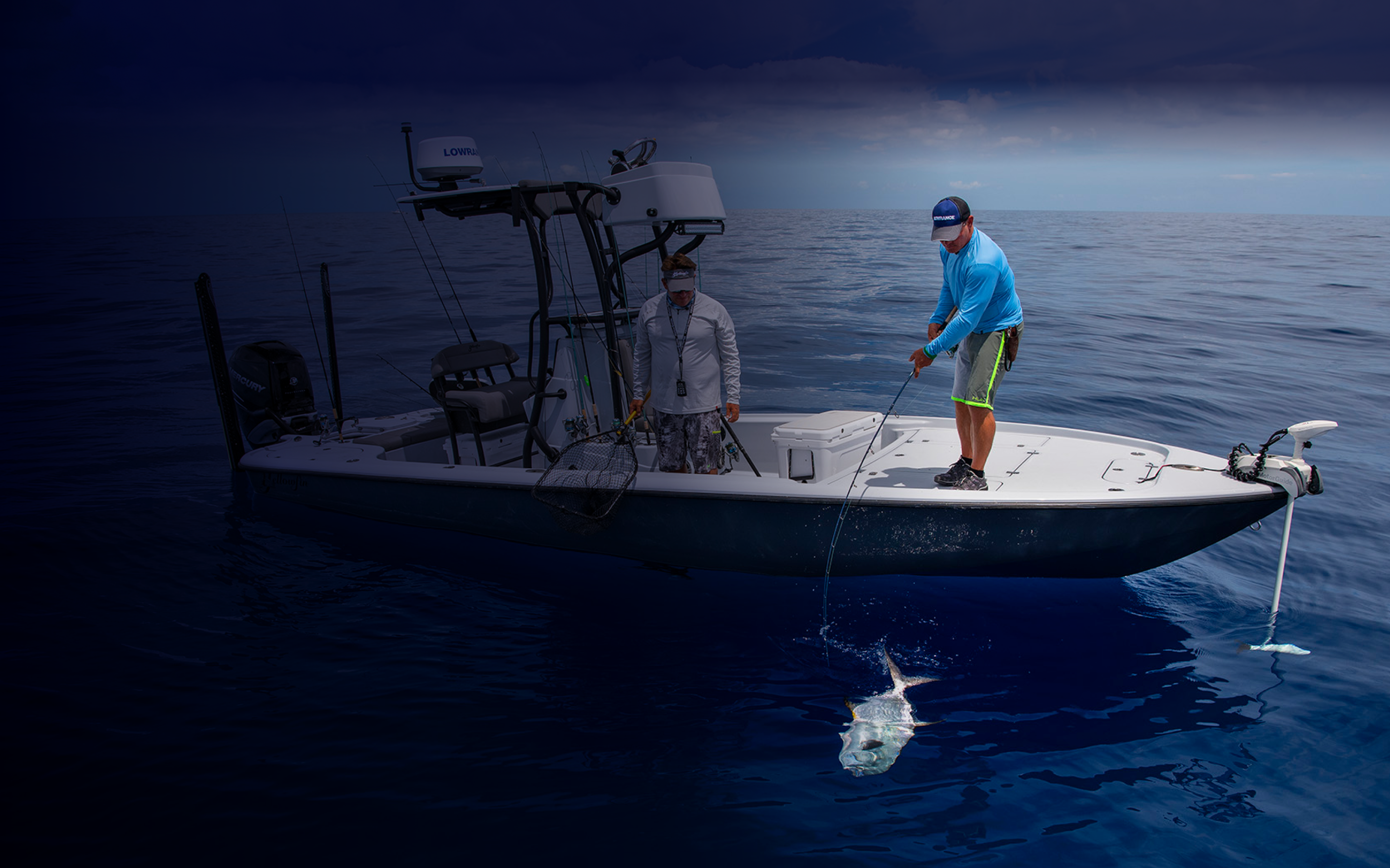 Two men fishing off a boat.