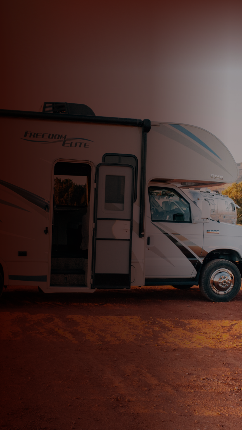 Family taking a picture next to an RV in the desert. 