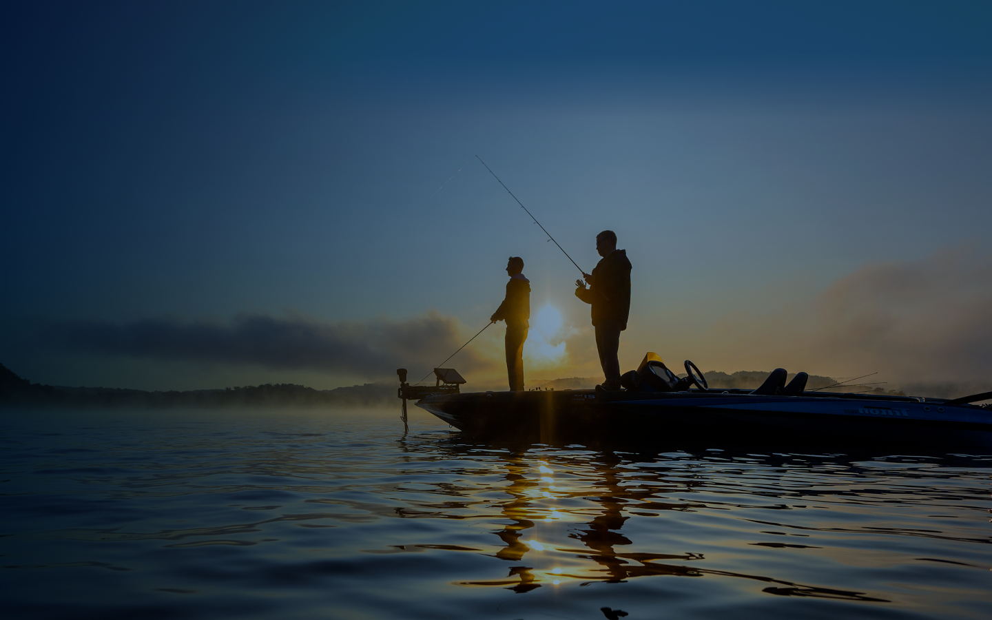 People peacefully fishing on a boat during sunset.