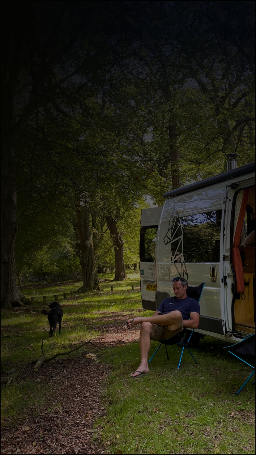 Man relaxing in chair outside of RV.